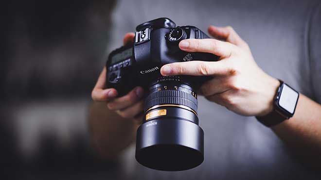 Person holding a digital camera